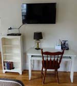 bookshelf, wall TV, white desk