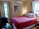 Thumbnail: queen bed with red spread, windows